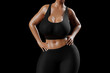 © PixlMakr - Young slim woman with big breasts in black sportswear