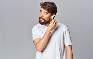 handsome guy in headphones on gray background white t-shirt emotions model