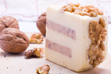 cheese with nuts on a wooden board