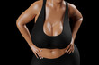 © PixlMakr - Young slim woman with big breasts in black sportswear