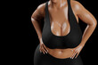 © PixlMakr - Young slim woman with big breasts in black sportswear