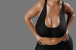© PixlMakr - Young slim woman with big breasts in black sportswear