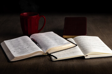 Wall Mural - Open bible and notebook with book of prayer and red mug