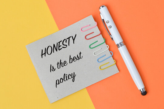 Top vie of pen and memo note written with quote HONESTY IS THE BEST POLICY. Motivational concept.