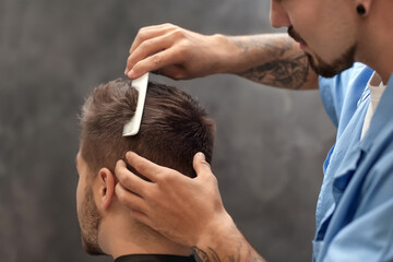 Canvas Print - Professional hairdresser working with client in barbershop