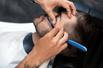 Sticker - Hairdresser shaving client in barbershop