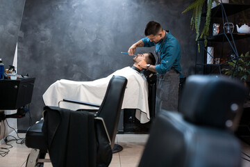 Poster - Hairdresser shaving client in barbershop