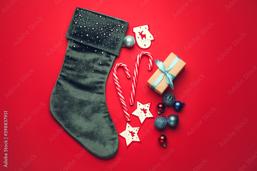 Composition with Christmas sock on color background