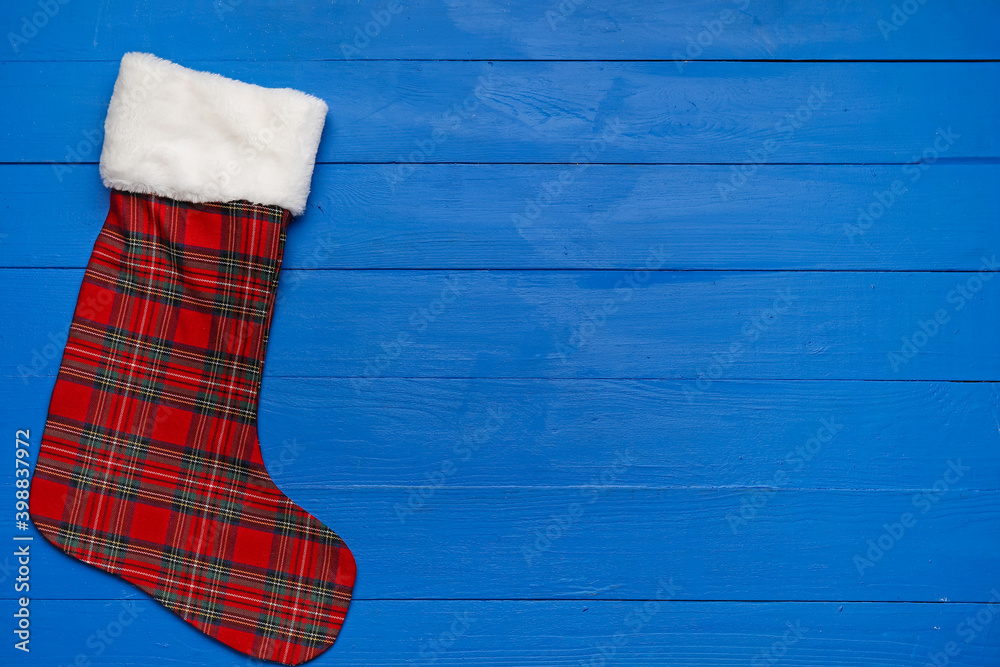 Christmas sock on color background