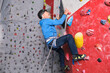 © Ladanifer - Professional senior man climbing on an artificial rock climbing wall. Extreme sports concept.