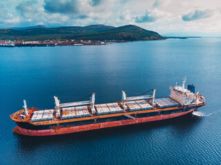 Largo ship sailing in still water near port of Kandalaksha Murmansk region in the White sea aerial view.