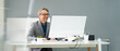 © Andrey Popov - Happy Professional Man Employee Using Computer
