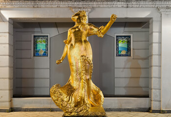 The statue of the golden lady at night in Batumi, Georgia