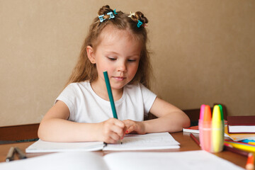 Canvas Print - Little girl doing homework writing and reading at home