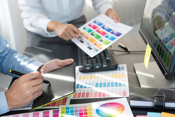Poster - graphic designer or creative working together coloring using graphics tablet and a stylus at desk wi