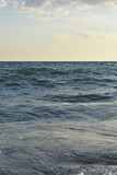 Fototapeta Morze - waves on the sea and yellow sky