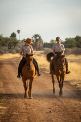 Poster - Blonde and brunette ride on dirt track