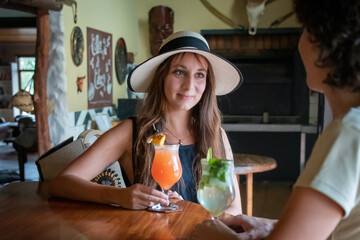 Sticker - Brunette in hat drinks with female friend