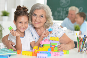 Sticker - Portrait of cute girl and grandmother playing