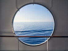 View Through Porthole With Blue Sea And View To Horizon 