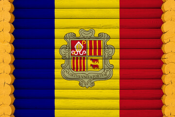 National flag  of Andorra on a wooden wall background. The concept of national pride and a symbol of the country. Flags painted on a house