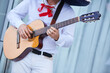 © Fotoproff - Stringed musical instrument acoustic guitar in the hands of a male musician.