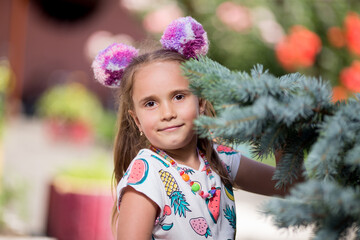 Little girl near the Christmas tree on the playground