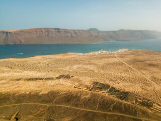 Aerial view of Caleta de Sebo, the main settlement and capital community of La Graciosa, Canary Islands. In the background El risco, the mountainous part to the north of Lanzarote
