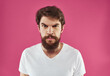 © SHOTPRIME STUDIO - Man with bushy beard on a pink background white t-shirt cropped view