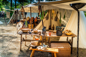 historical reenactment of slavic or vikings tribe tent camp with food on wooden table and drying her