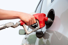 Isolated Arm And Hand Of A Young Man Pumping Gas Into A Car