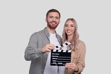 Couple Holding Clapperboard Isolated. Couple Movie Concept