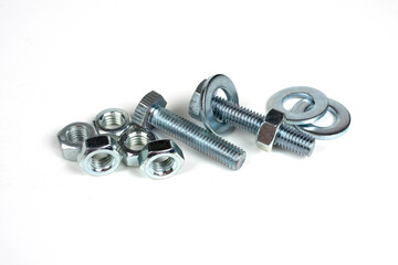 group of bolts and nuts made of metal on a white background