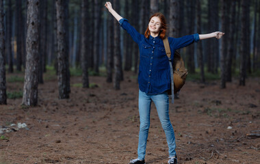 Woman hiker with backpack in forest nature lifestyle adventure