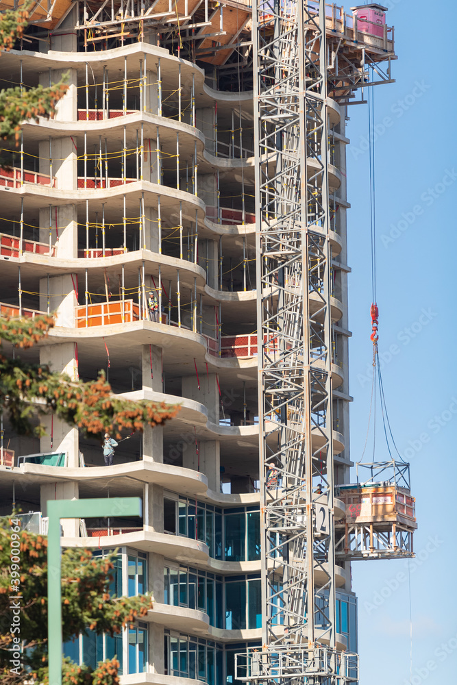 Long hoisting tower crane in construction new apartment building ...