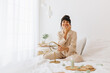 © (JLco) Julia Amaral - Smiling woman doing skin care at home