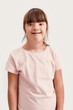 © Svitlana - Portrait of disabled girl with Down syndrome smiling at camera while posing isolated over white background