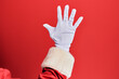 © Krakenimages.com - Hand of a man wearing santa claus costume and gloves over red background counting number 5 showing five fingers