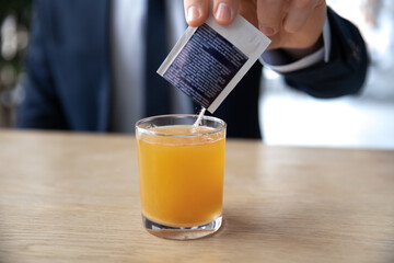 Close up sick businessman pouring powder medicine for cold or cough into glass of water, employee office worker taking medication, relieving fever, influenza or flu symptoms, healthcare concept