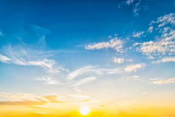 Wall Mural - Sky at sunset blue and orange light of the sun through the clouds in the sky