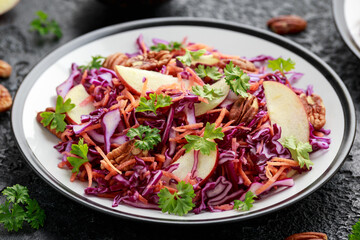 Wall Mural - Red Cabbage salad with carrots, apples and pecan nuts. Healthy vegan food