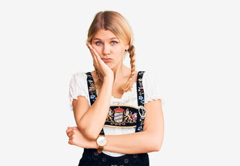 Wall Mural - Young beautiful blonde woman wearing oktoberfest dress thinking looking tired and bored with depression problems with crossed arms.