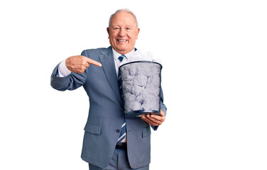 Wall Mural - Senior handsome grey-haired man holding paper bin with crumpled document pointing finger to one self smiling happy and proud