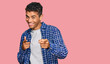 © Krakenimages.com - Young handsome african american man wearing casual clothes pointing fingers to camera with happy and funny face. good energy and vibes.