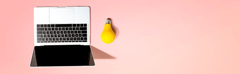 Aufkleber - Laptop computer with a yellow light bulb from above