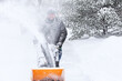 © soupstock - Man using a snowblower to clear his sidewalk and driveway