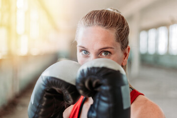 Indoors portrait of young, fit female boxer. Sport, active lifestyle.