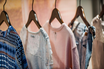 Wall Mural - Women clothing on hangers in a mall - shopping in mall concept