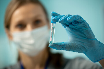 Poster - Gloved hand of researcher holding small flask with sample of new vaccine