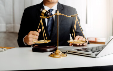 Business and lawyers discussing contract papers with brass scale on desk in office. Law, legal services, advice, justice and law concept picture with film grain effect